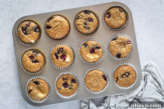 Overhead view of Cherry Cheesecake Muffins baking in a muffin pan.