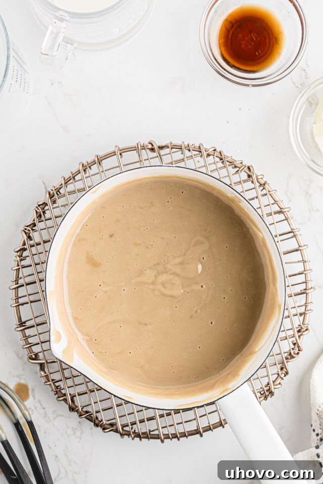 The butterscotch pudding mixture gently simmering in the saucepan, thickening beautifully as it cooks.