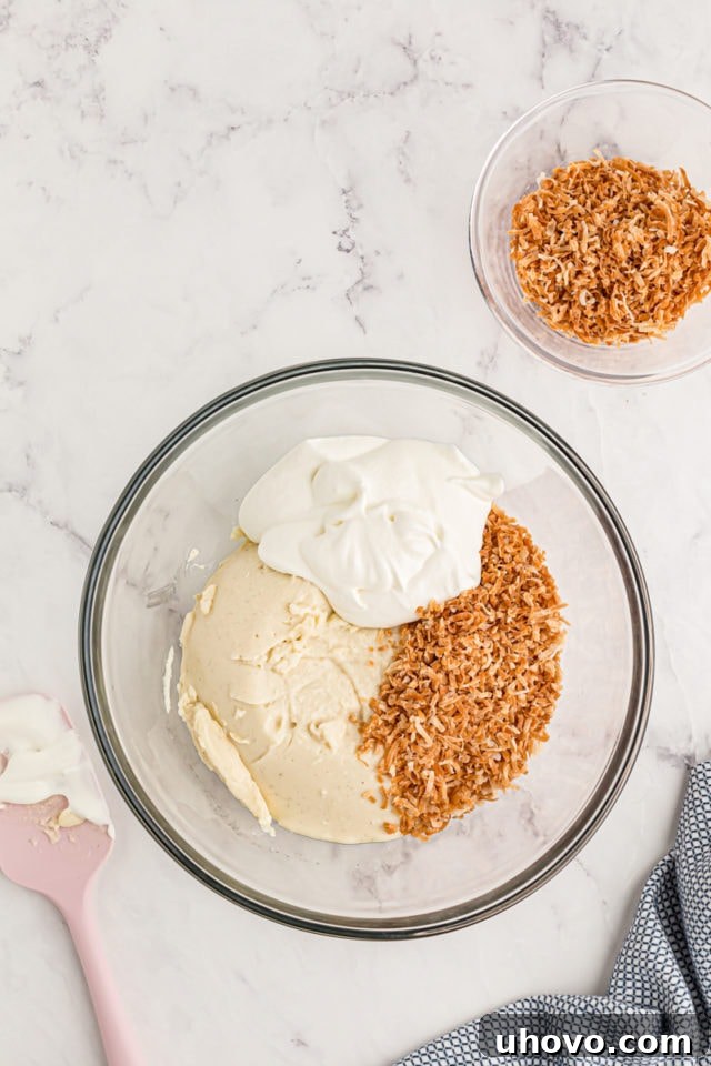 Overhead view of vanilla pudding, whipped cream, and toasted coconut in bowl