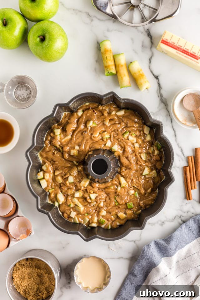 apple spice cake batter in a Bundt pan