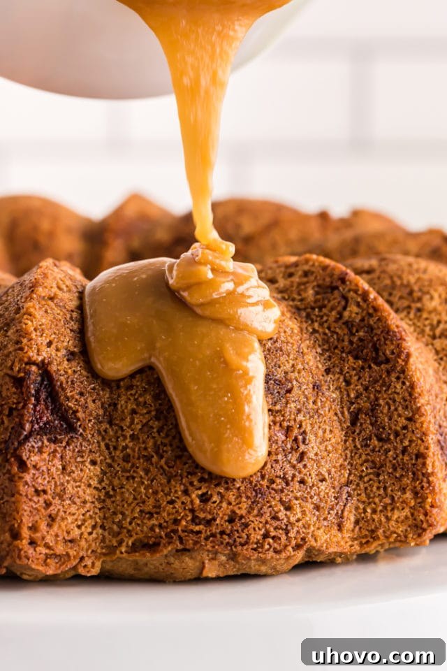 caramel glaze being poured onto Apple Spice Cake