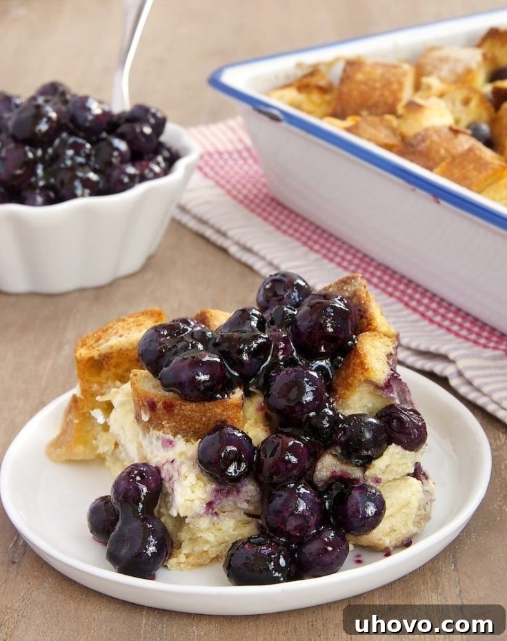 Blueberry bread pudding on plate with sauce