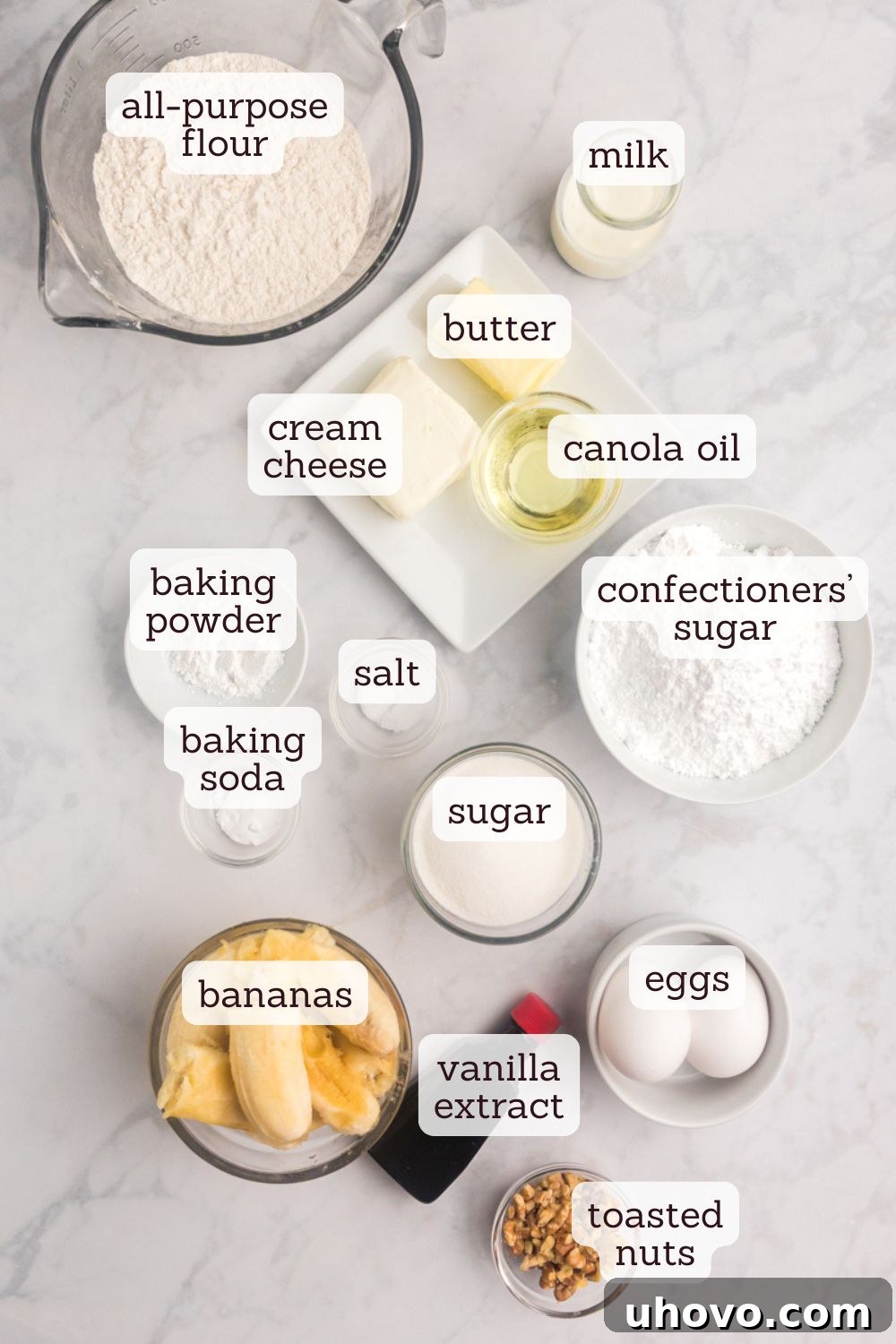 An overhead shot showcasing an assortment of fresh ingredients neatly arranged, ready for baking this delightful banana cake with cream cheese frosting.