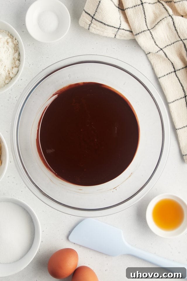 Overhead view of melted butter and chocolate in glass bowl, smooth and glossy.