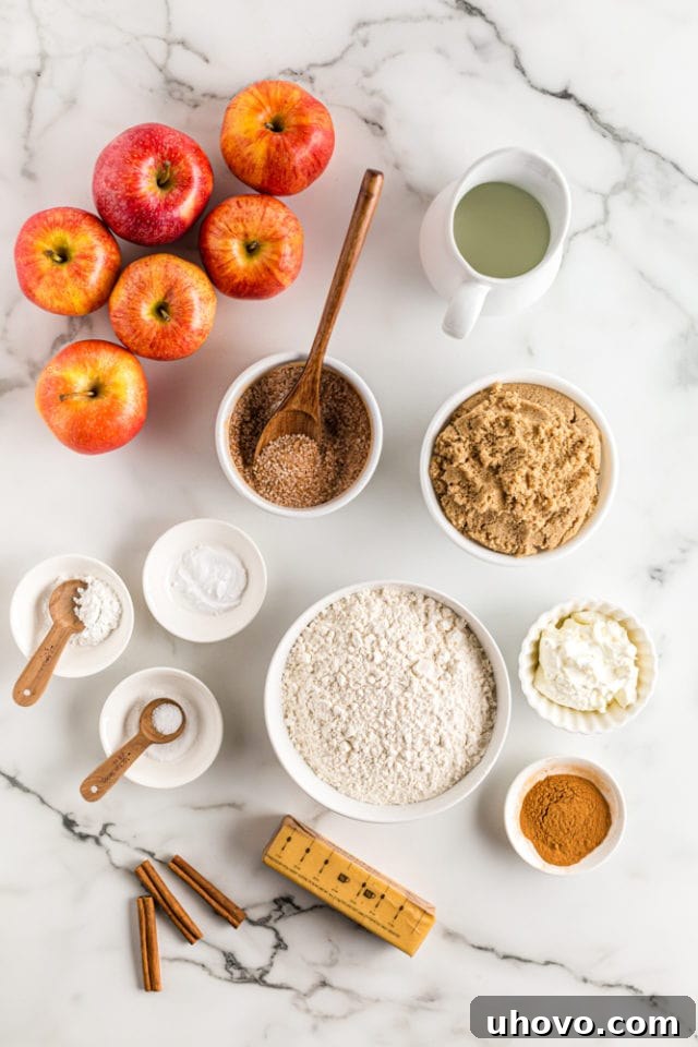 An overhead view showcasing the fresh ingredients laid out for making Brown Sugar Apple Cobbler, including apples, brown sugar, flour, and cinnamon.