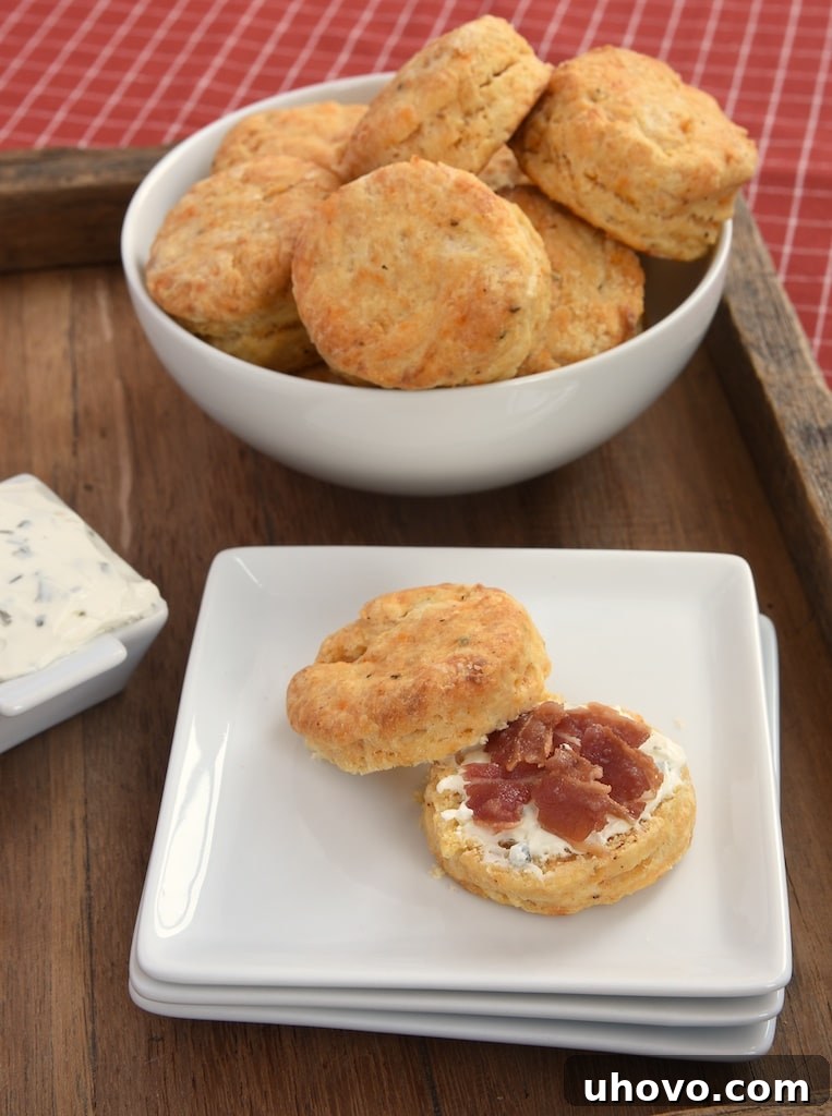 Savory spices and a hint of hot sauce infuse these Cream Cheese Biscuits with irresistible flavor, making them a perfect snack or meal accompaniment for any occasion.