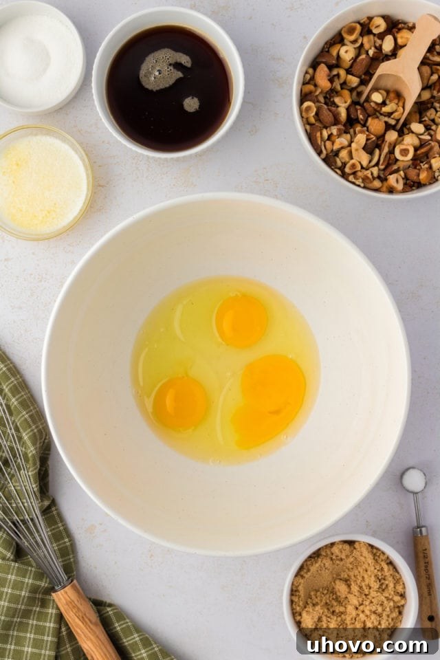 Overhead view of cracked eggs in mixing bowl