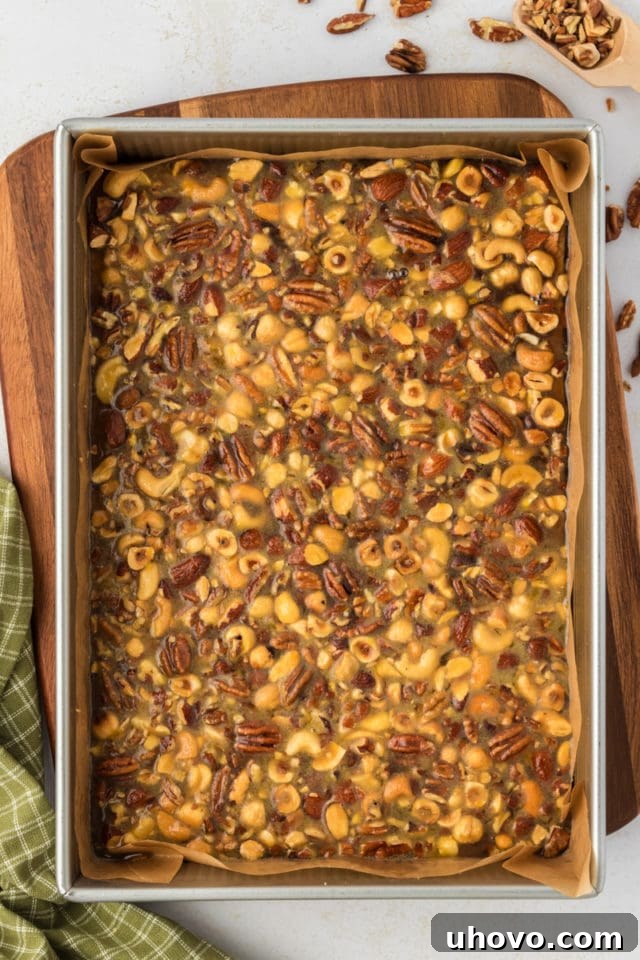 Overhead view of maple nut bars in parchment-lined pan