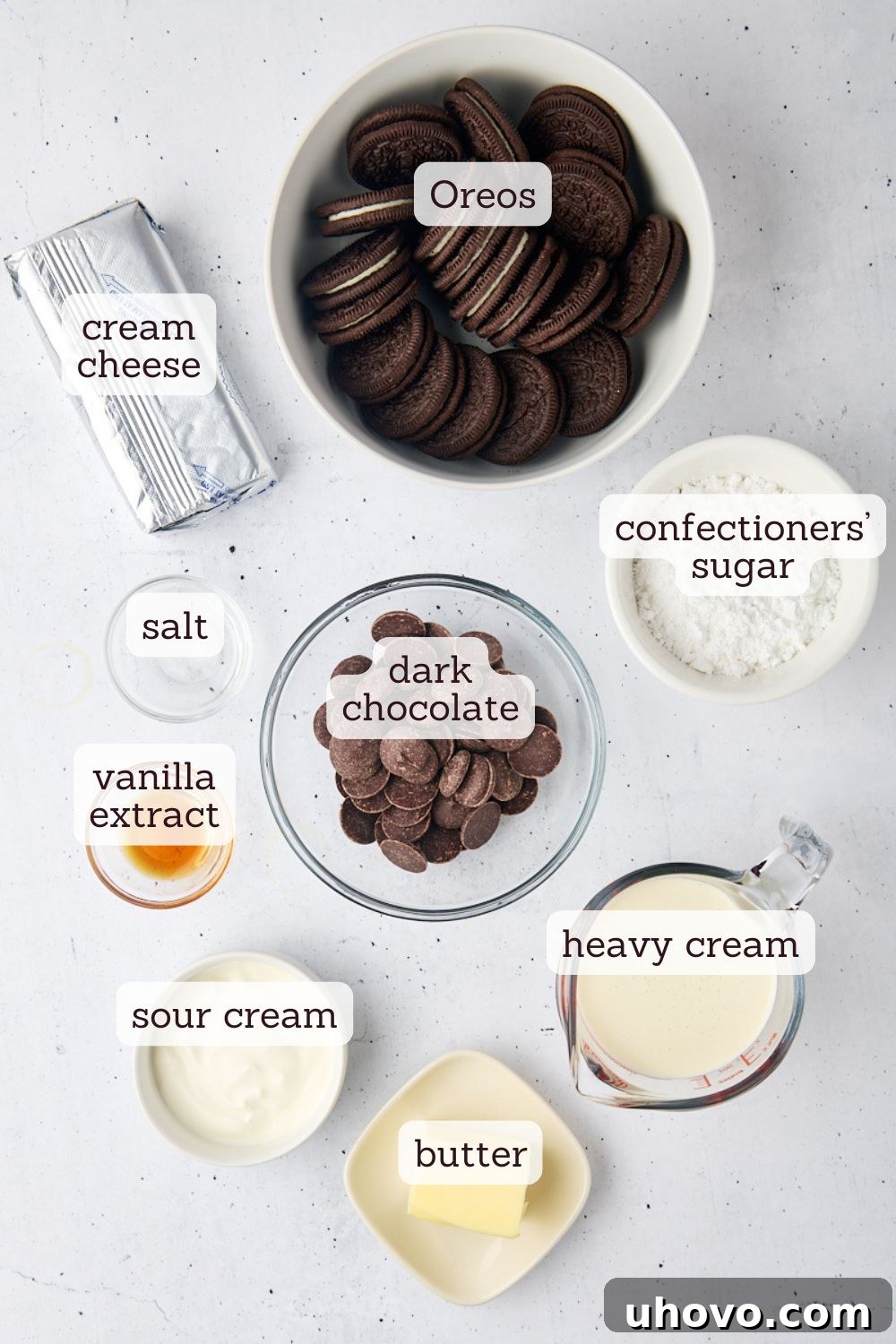 Overhead view of all the essential ingredients laid out for preparing mini no-bake chocolate cheesecakes, highlighting freshness and readiness.