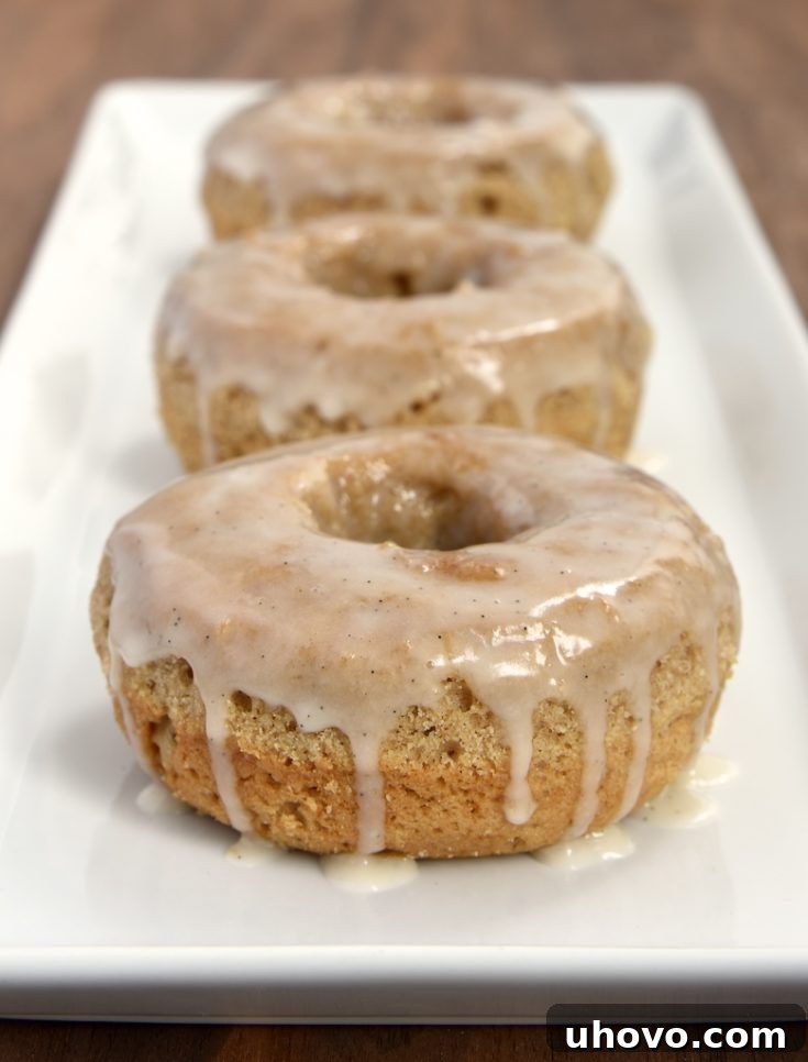 These baked doughnuts are flavored with lots of delicious spices and topped with a sweet vanilla glaze.