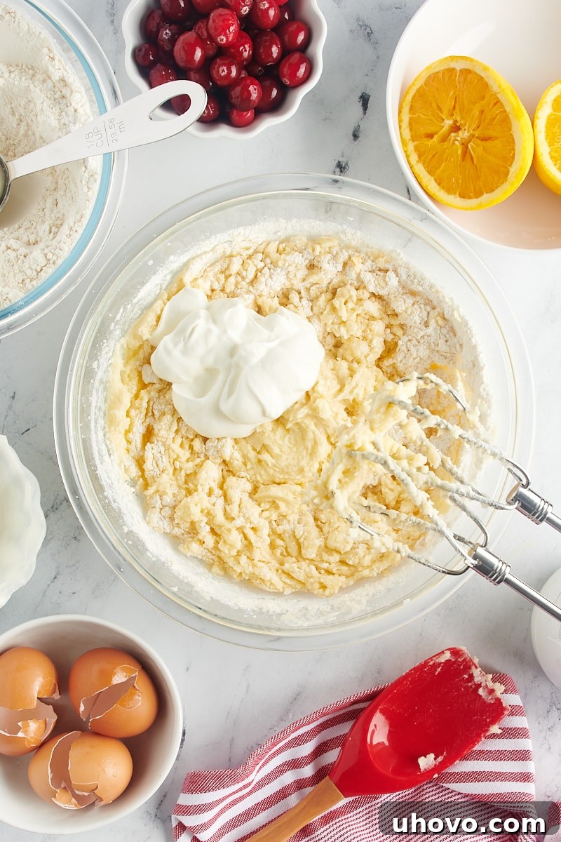 Adding a portion of sour cream to the cake batter, alternating with dry ingredients for a moist texture.