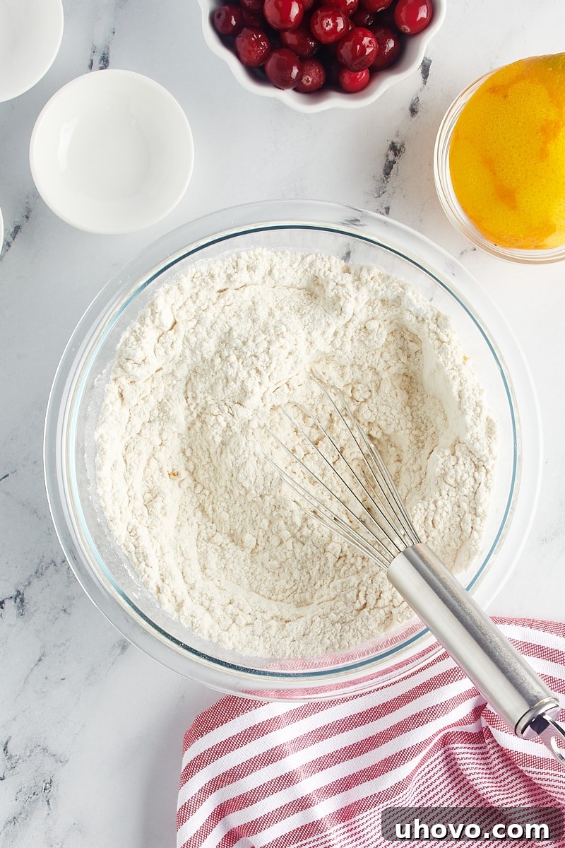 A glass bowl showing the combined and whisked dry ingredients for the Bundt cake batter, ready for the next step.