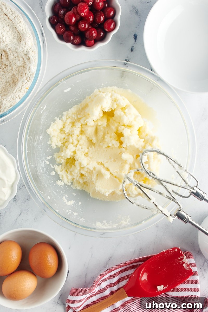 Creamed butter and sugar in a glass bowl, now light and fluffy after being beaten with an electric mixer.