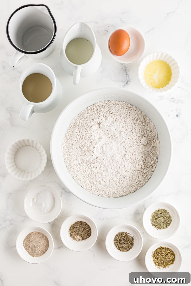 All the fresh and dried ingredients for Herb Cloverleaf Rolls neatly laid out on a kitchen counter, ready for baking.