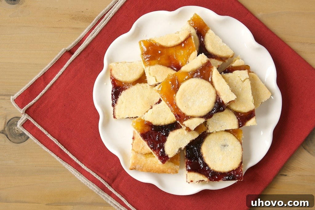 Freshly baked Linzer Bars cooling on a wire rack, ready to be cut into individual servings.
