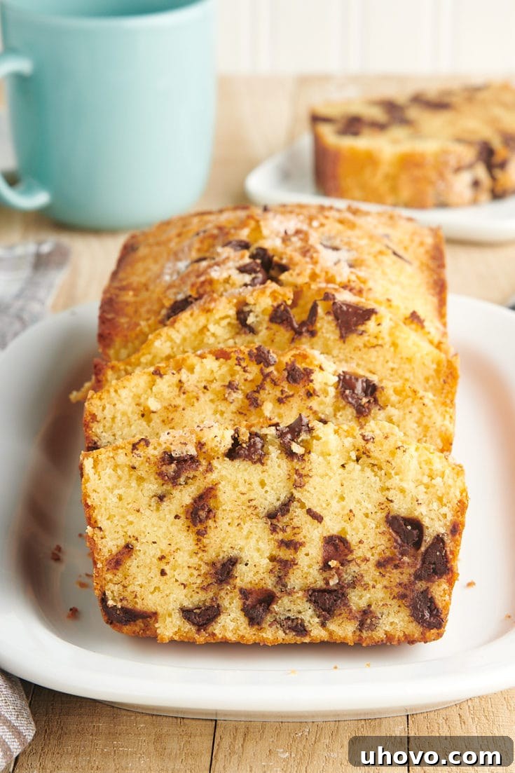 A slice of Chocolate Chip Loaf Cake with melted chocolate chips.