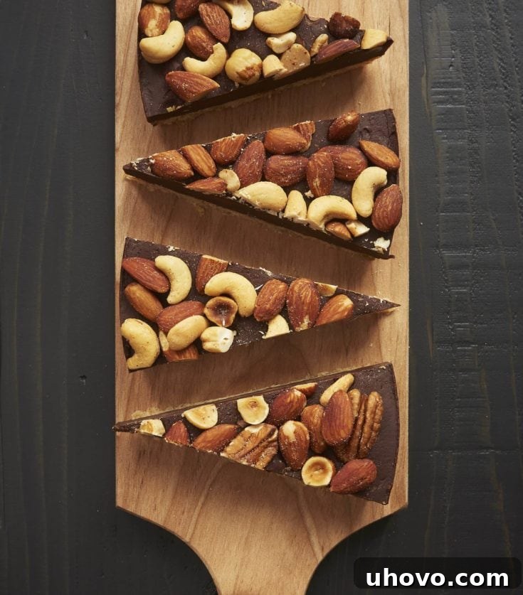 A beautifully arranged Fudgy Nut Tart with various nuts.
