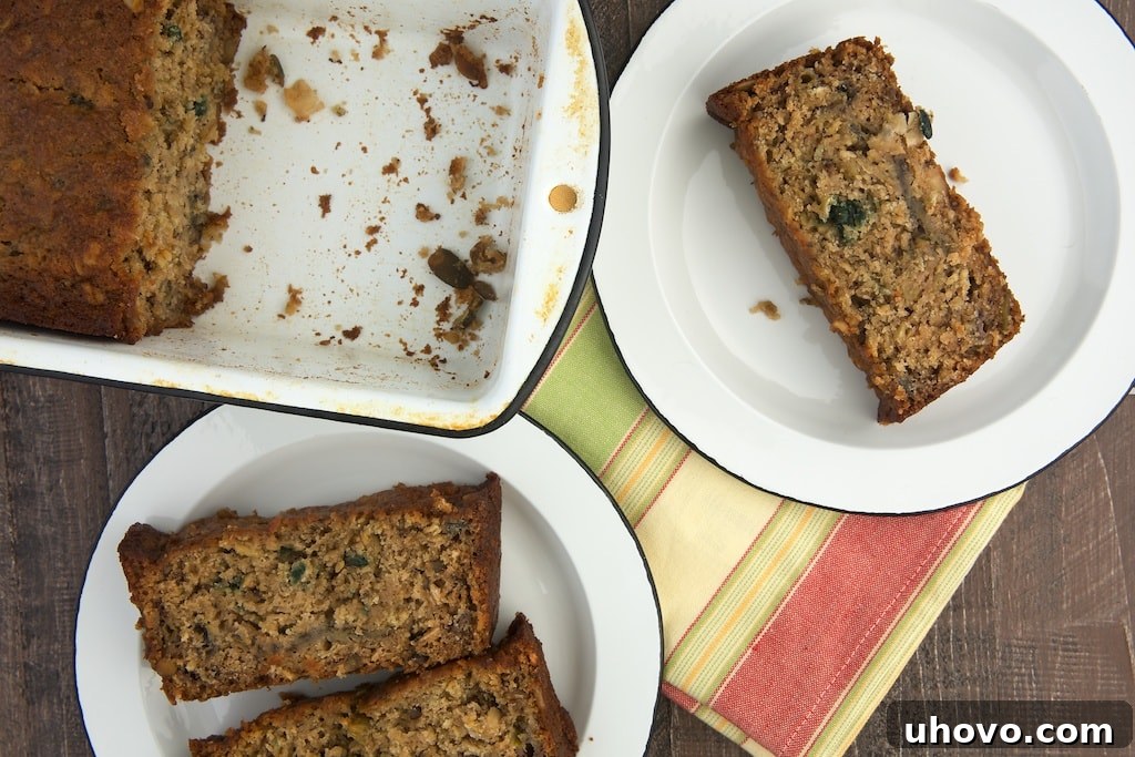 overhead view of slices of Granola Banana Bread on white plates, showing the inviting texture and granola pieces