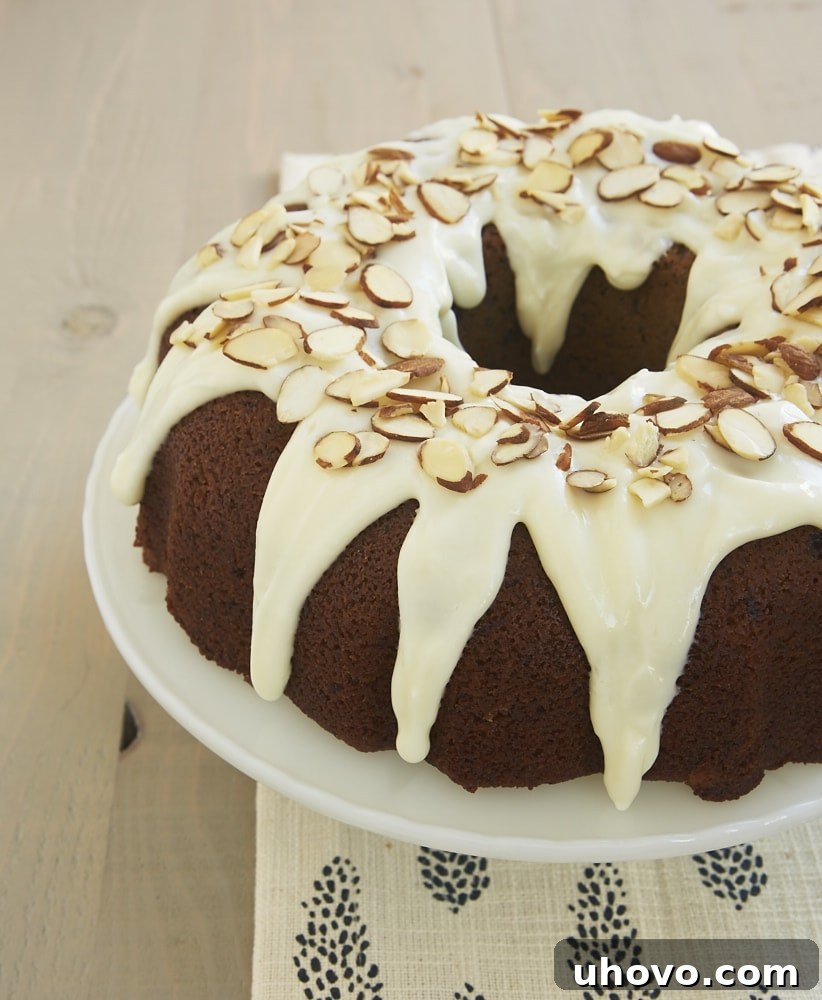 Blueberry Jam Cake topped with a cream cheese glaze and almonds - Bake or Break
