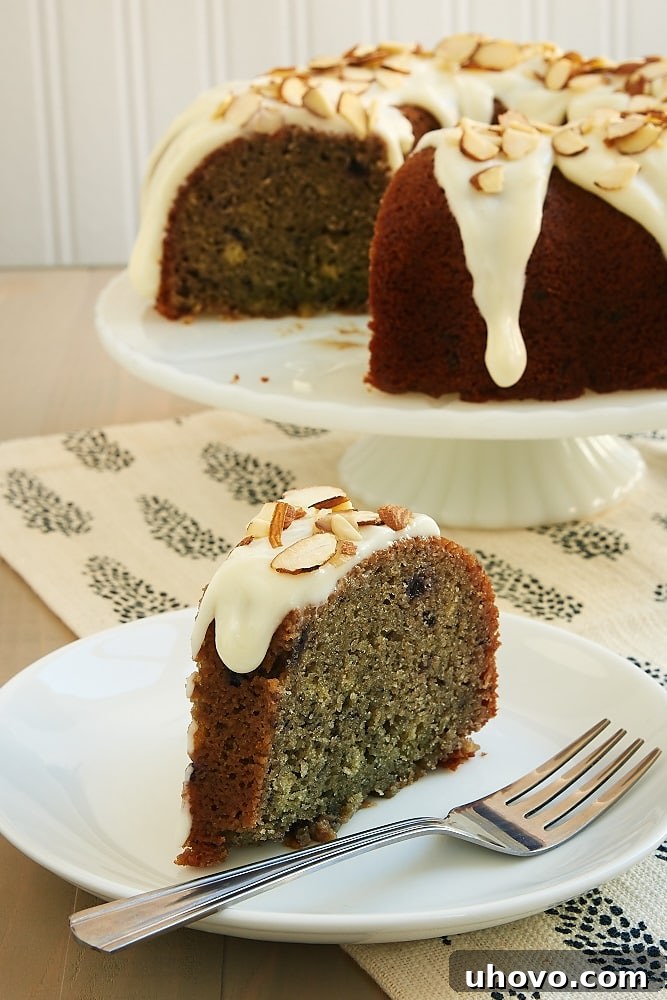 Blueberry Jam Cake topped with a cream cheese glaze and almonds - Bake or Break