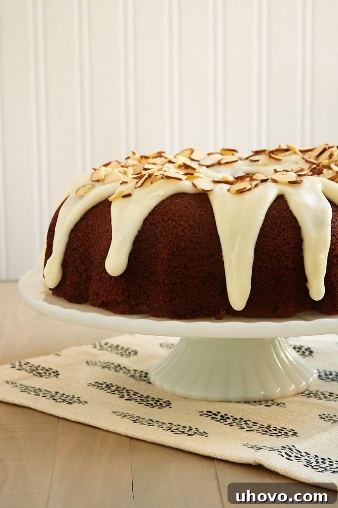 Blueberry Jam Cake topped with a cream cheese glaze and almonds - Bake or Break