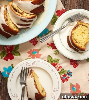overhead view of slices of Cinnamon Breakfast Cake on color-rimmed white plates
