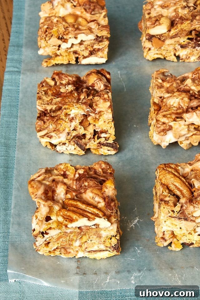 Sweet and Nutty Corn Flake Bars neatly arranged on waxed paper, on a rustic blue fabric background