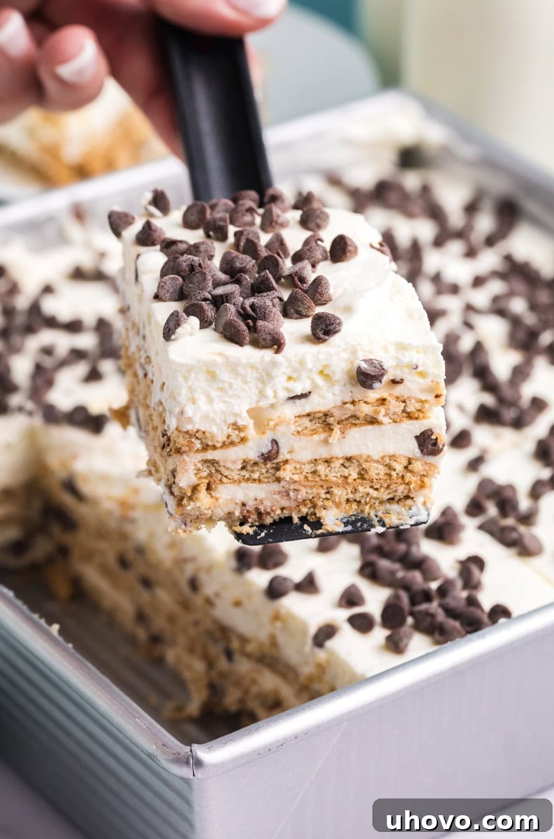 a slice of cannoli icebox cake being lifted away from the remaining cake