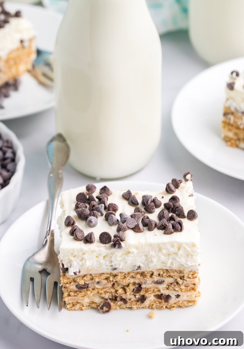 a slice of cannoli icebox cake on a white plate with more servings and a bottle of milk in the background