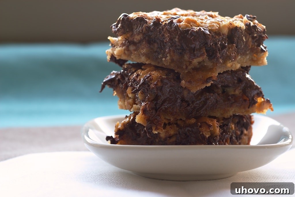 Gooey and rich Chocolate Cashew Bars cooling on a wire rack, packed with chocolate chips and chopped cashews.