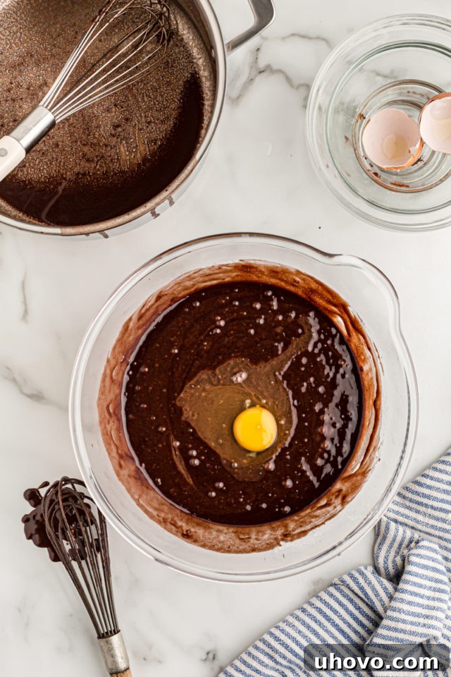 Overhead view of egg added to cake batter