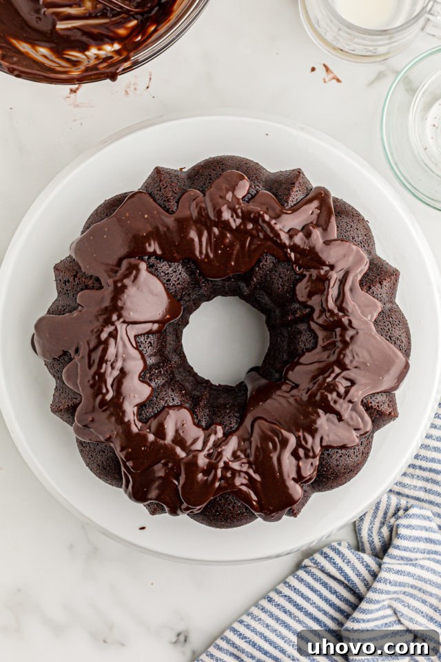 Overhead view of glazed chocolate sour cream Bundt cake on cake stand