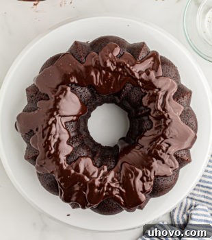 Overhead view of glazed chocolate sour cream Bundt cake on cake stand
