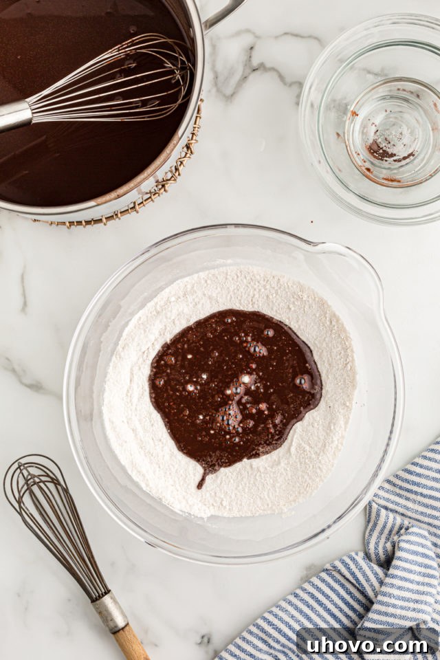 Overhead view of chocolate mixture added to dry ingredients