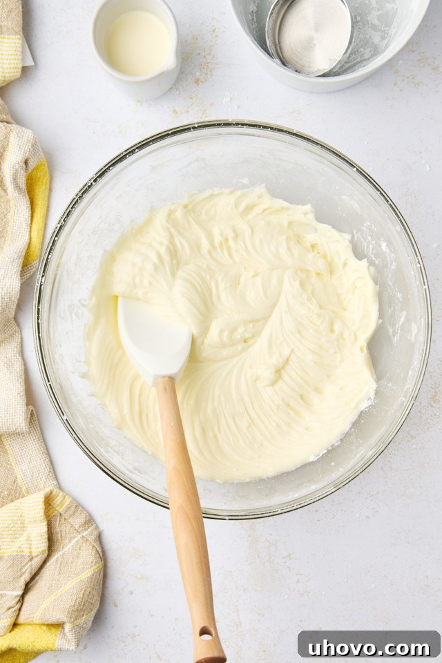 overhead view of lemon cream cheese frosting in a mixing bowl