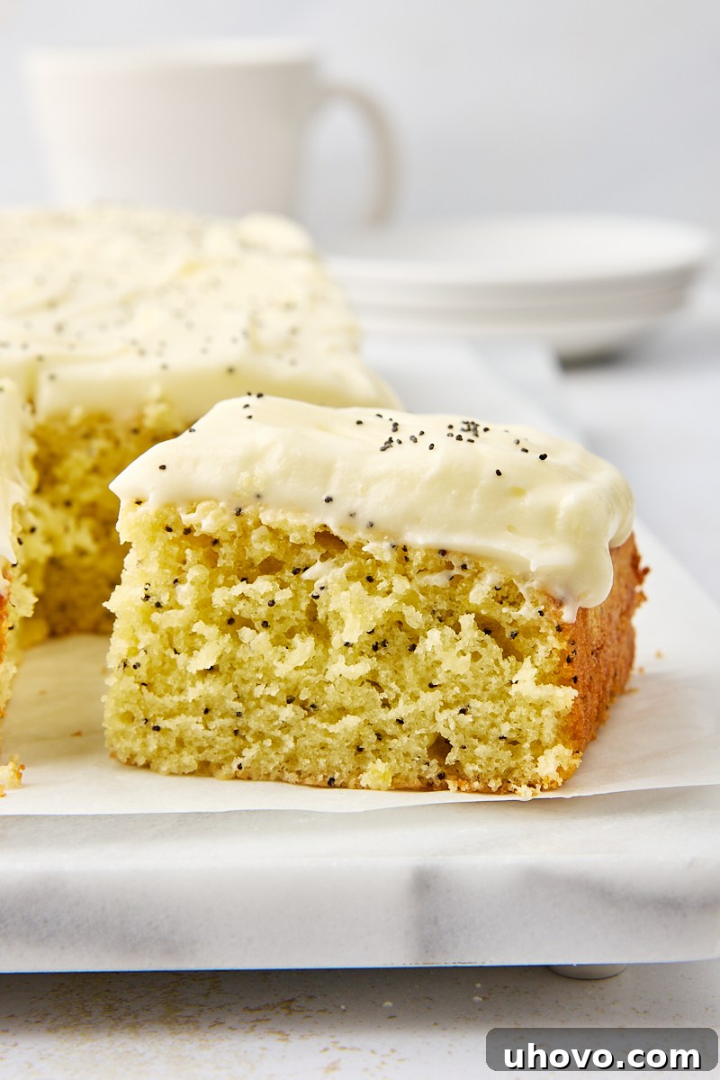 partially sliced lemon poppy seed cake on a marble serving tray
