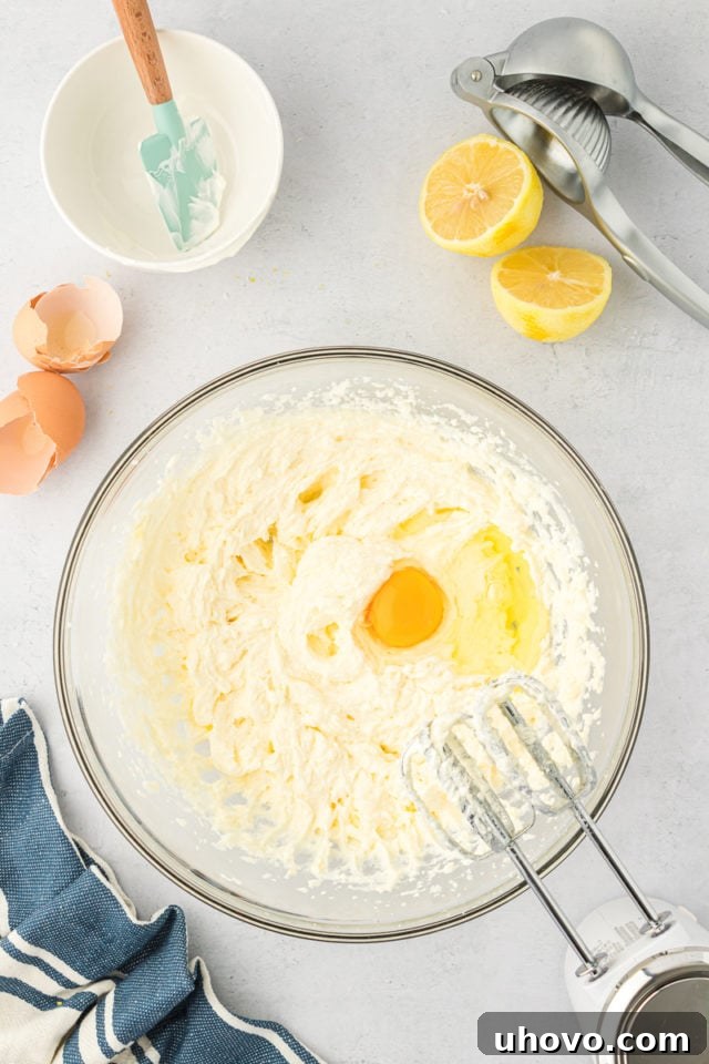 overhead view of an egg added to partially mixed cookie dough