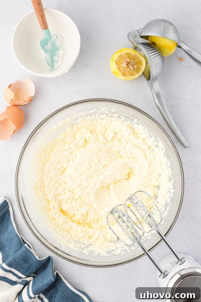 overhead view of lemon juice added to partially mixed cookie dough