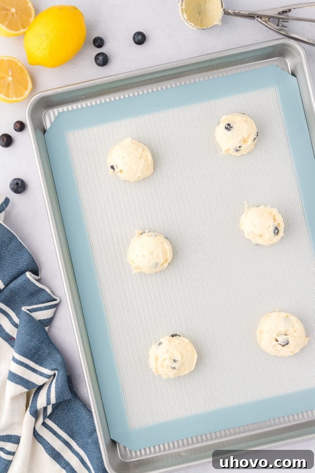 overhead view of lemon blueberry cookies on a baking sheet ready to go into the oven