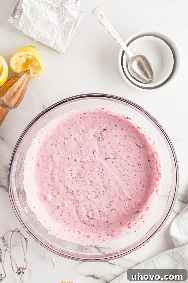 Overhead view of the combined cream cheese and berry mixture, smoothly blended in a bowl