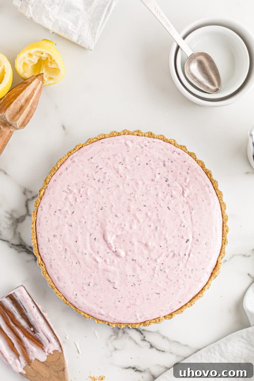 Triple berry no-bake cheesecake in its pan, before chilling, showing the smooth top