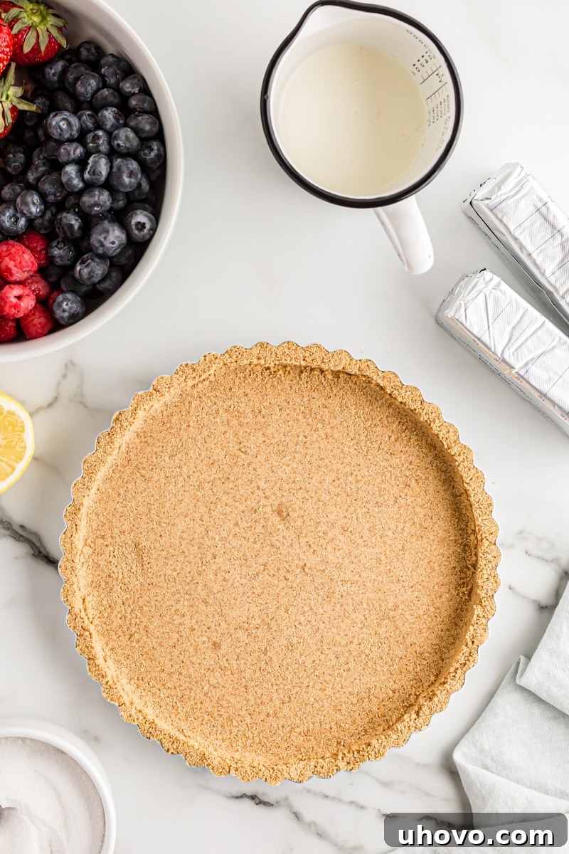 Overhead view of a perfectly pressed graham cracker pie crust in a springform pan
