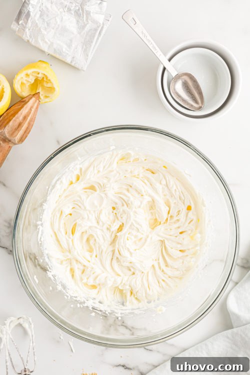 Overhead view of the smoothly beaten cream cheese mixture in a mixing bowl