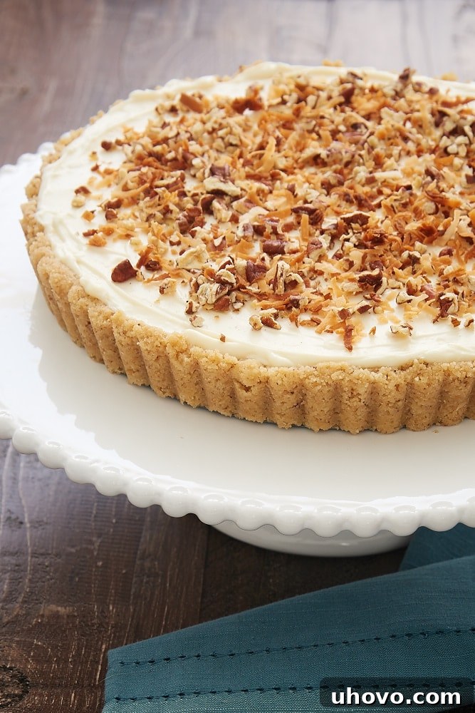 A close-up view of the Italian Cream Tart, generously topped with toasted coconut flakes, showcasing its enticing texture.
