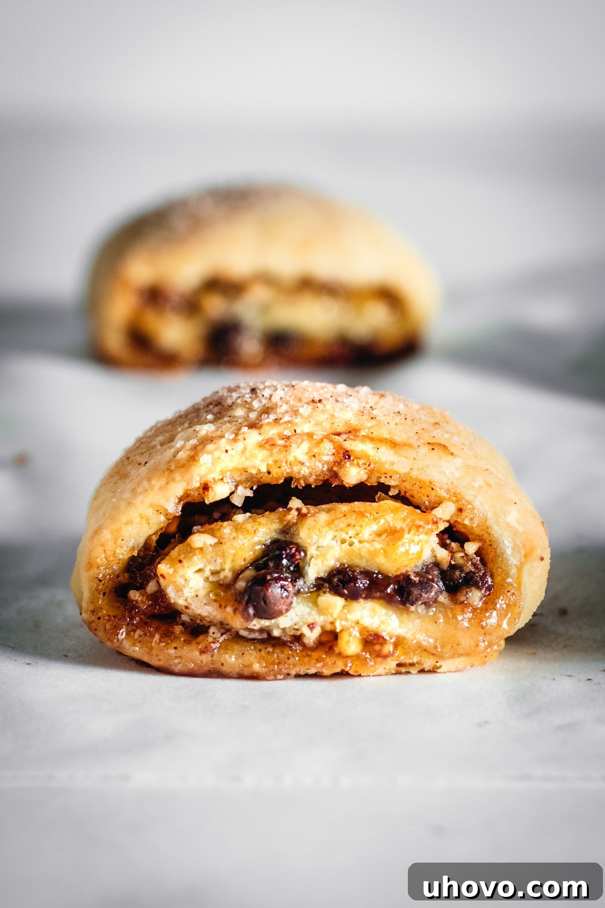 Closeup of rectangle rugelach showcasing golden-brown crust and visible filling