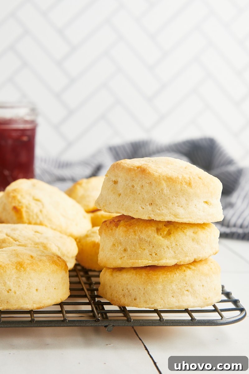 A stack of golden brown cream biscuits resting on a wire rack, ready to be enjoyed.
