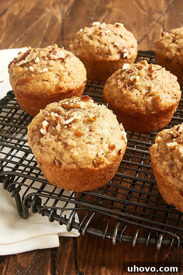 Close-up of Pecan Spice Muffins with a dusting of turbinado sugar on top, arranged on a cooling rack.