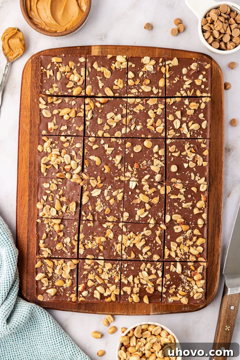A delightful overhead view of perfectly sliced chocolate peanut butter rice crispy treats, arranged invitingly on a wooden cutting board, ready to be enjoyed.