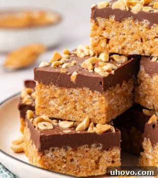 chocolate peanut butter rice crispy treats stacked on a white plate