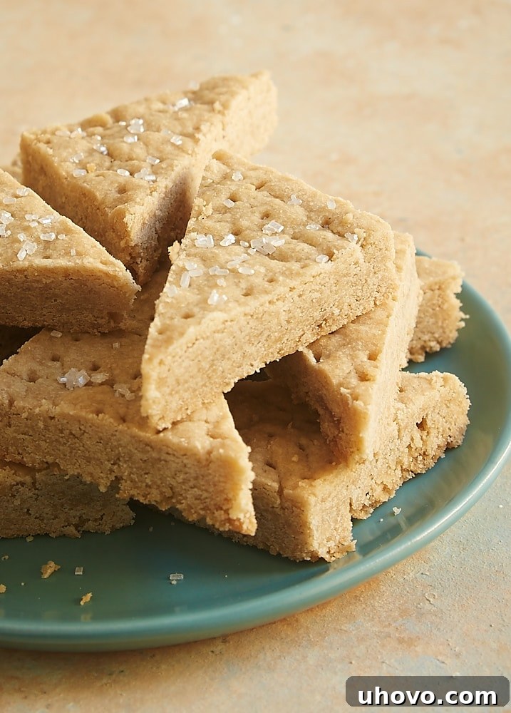 Triangular brown sugar shortbread pieces arranged artfully, highlighting their golden edges.